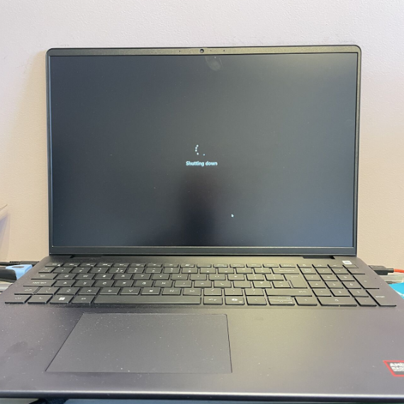 A closed laptop displaying a loading screen on a flat surface.