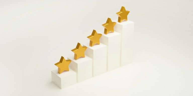 Gold stars on ascending white blocks, symbolising achievement and progress.